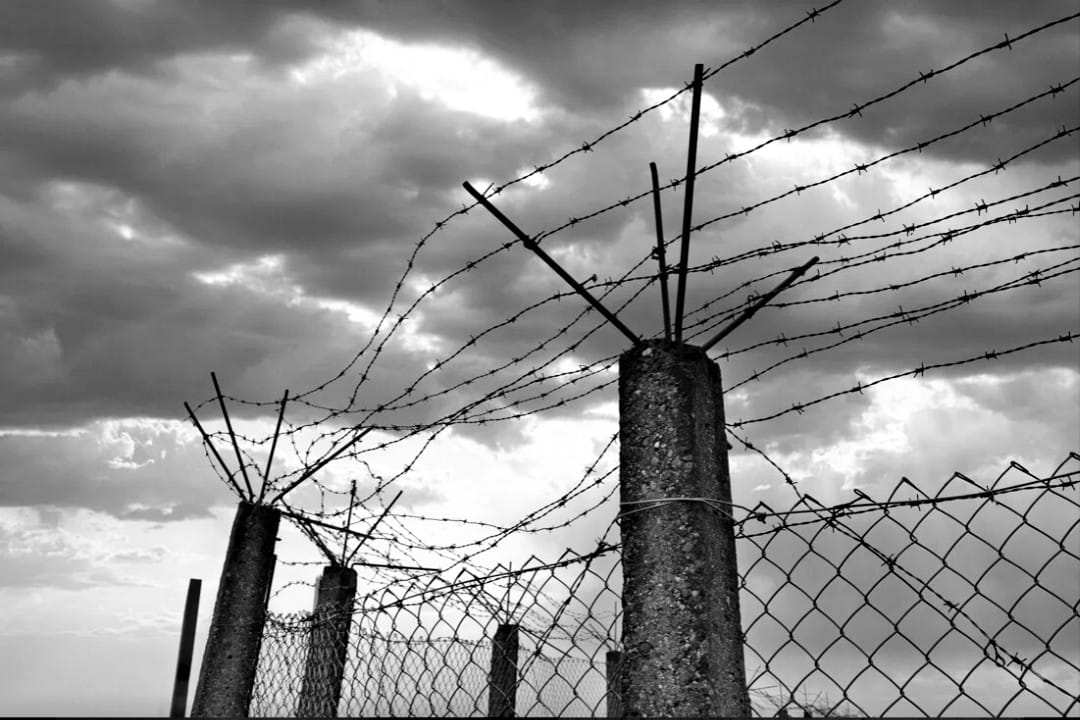 The high fences and barbed wire surrounding the fort. These barriers were not just physical but psychological, isolating prisoners from the outside world.