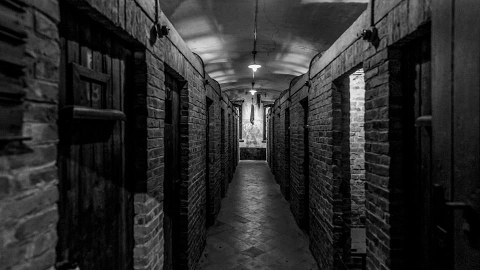 The small, dark isolation cells for severe punishment. In these suffocating spaces, prisoners were left alone with their thoughts and the darkness.