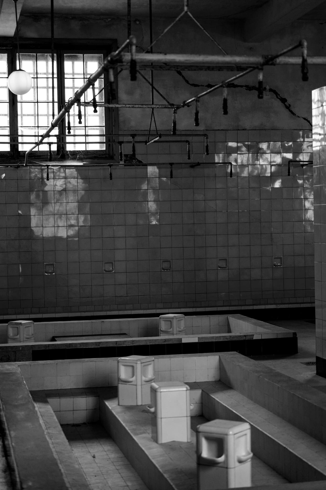The sanitary areas or showers in the camp. Often places of humiliation rather than hygiene, stripping prisoners of their last shreds of privacy.