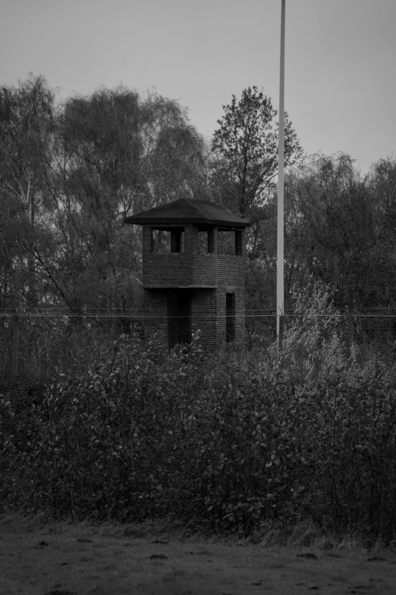 A watchtower from which guards oversaw the camp. A symbol of the constant surveillance and the impossibility of escape for the prisoners below.